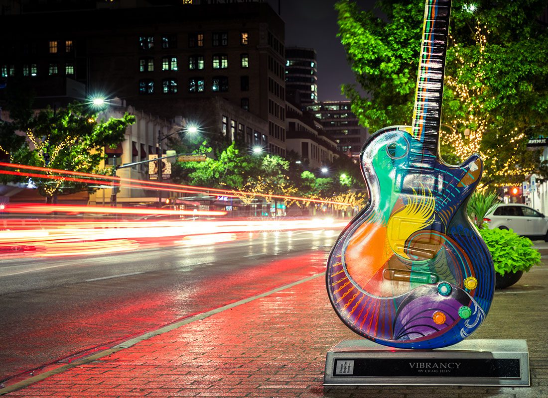 Austin, TX - Closeup View of a Colorful Guitar on the Sidewalk in Downtown Austin Texas at Night