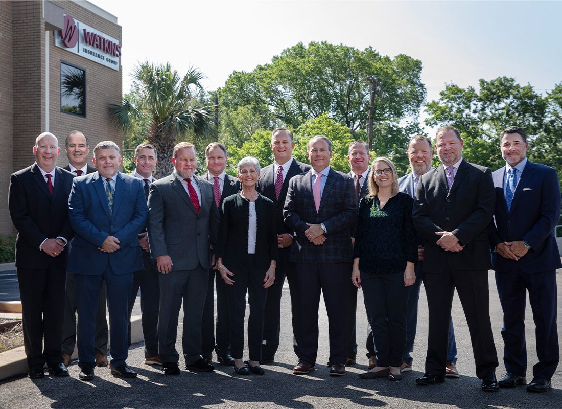 Who We Are - Portrait Of Shareholders Part of Watkins Insurance Group Standing Outside Of The Office Building