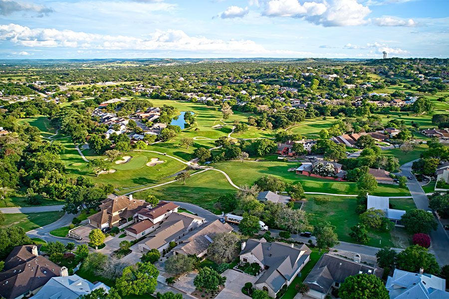 Bee Cave, TX - Bird’s-Eye View of the Surroundings of Residential Buildings and Beautiful Green Fields